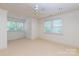 Bright, airy bedroom with two sets of windows and neutral carpet flooring and a ceiling fan at 3408 Sandalwood Ln, Waxhaw, NC 28173