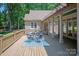 Wonderful deck with a covered area, stone columns, an outdoor table, and wooded views at 3408 Sandalwood Ln, Waxhaw, NC 28173
