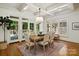 Formal dining room with a beautiful chandelier, a wooden table, and multiple windows at 3408 Sandalwood Ln, Waxhaw, NC 28173