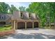 Three-car garage doors provide ample parking and storage space with a driveway at 3408 Sandalwood Ln, Waxhaw, NC 28173