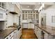 Spacious kitchen featuring custom cabinets, a gas range, granite counters, and hardwood floors at 3408 Sandalwood Ln, Waxhaw, NC 28173