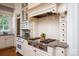 Close up of a kitchen featuring granite countertops, a gas range, and custom cabinetry at 3408 Sandalwood Ln, Waxhaw, NC 28173