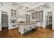 Bright, open kitchen features an island with seating and stainless steel appliances and a coffered ceiling at 3408 Sandalwood Ln, Waxhaw, NC 28173
