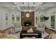 Cozy living room featuring a stone fireplace, hardwood floors and a coffered ceiling at 3408 Sandalwood Ln, Waxhaw, NC 28173