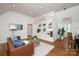 Living room features built-in shelving with a brown leather couch at 3408 Sandalwood Ln, Waxhaw, NC 28173