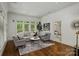Bright living room with large windows, hardwood floors, and stylish neutral furnishings at 3408 Sandalwood Ln, Waxhaw, NC 28173