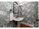 Charming powder room features pedestal sink with vintage wallpaper at 3408 Sandalwood Ln, Waxhaw, NC 28173