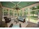 Screened-in porch with a comfortable seating arrangement and serene views of the backyard at 3408 Sandalwood Ln, Waxhaw, NC 28173