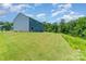 Expansive green backyard, perfect for outdoor activities and relaxation next to a private treeline at 3654 Azalea Ridge Dr, Mount Holly, NC 28102