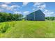 Large backyard offers plenty of room for recreation or gardening with lush green grass at 3654 Azalea Ridge Dr, Mount Holly, NC 28102