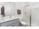 Bright bathroom featuring a modern vanity and walk-in shower with glass doors at 3654 Azalea Ridge Dr, Mount Holly, NC 28102