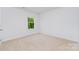 Simple bedroom with neutral carpet and a bright window at 3654 Azalea Ridge Dr, Mount Holly, NC 28102