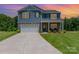 Charming two-story home featuring stone accents, attached two-car garage, and manicured lawn at 3654 Azalea Ridge Dr, Mount Holly, NC 28102