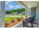 Inviting front porch with wicker chairs and landscaping, perfect for relaxing outdoors at 3654 Azalea Ridge Dr, Mount Holly, NC 28102
