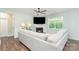 Bright living room featuring a fireplace, ceiling fan, and view from the large window at 3654 Azalea Ridge Dr, Mount Holly, NC 28102