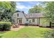 Inviting backyard features a patio with outdoor seating and a lush lawn at 3909 Woodbriar Trl, Charlotte, NC 28205