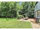 Landscaped backyard with patio set is perfect for outdoor entertaining at 3909 Woodbriar Trl, Charlotte, NC 28205