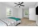 Cozy bedroom with plush carpet, a large window, and a comfortable bed with a patterned quilt at 3909 Woodbriar Trl, Charlotte, NC 28205