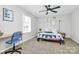 Inviting bedroom with a desk, a cozy bed, and ample natural light at 3909 Woodbriar Trl, Charlotte, NC 28205