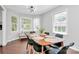Sunlit dining room showcasing a large table, modern chairs, and bright natural light at 3909 Woodbriar Trl, Charlotte, NC 28205