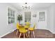 Cozy dining room featuring a glass table with yellow chairs and plenty of natural light at 3909 Woodbriar Trl, Charlotte, NC 28205