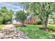 Lovely exterior view of a property featuring a red brick house and white siding, surrounded by green lawn and trees at 3909 Woodbriar Trl, Charlotte, NC 28205