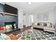 Inviting living room featuring a decorative fireplace, a cozy sofa, and a stylish glass coffee table at 3909 Woodbriar Trl, Charlotte, NC 28205