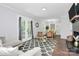 Bright living room with a fireplace, French doors, neutral furniture, and stylish decor at 3909 Woodbriar Trl, Charlotte, NC 28205