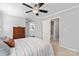 Bedroom with neutral paint, ceiling fan, and bathroom access at 4103 Christine Ln # E, Waxhaw, NC 28173