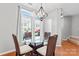 Bright breakfast nook features hardwood floors, modern chandelier, and large window at 4103 Christine Ln # E, Waxhaw, NC 28173