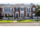 Charming townhome with brick and white siding, a picket fence, and well-manicured lawn at 4103 Christine Ln # E, Waxhaw, NC 28173