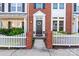Inviting front entrance featuring a black door, a wreath, and a white picket fence at 4103 Christine Ln # E, Waxhaw, NC 28173