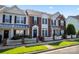 Charming townhome with brick accents, a black front door, and a white picket fence at 4103 Christine Ln # E, Waxhaw, NC 28173