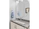 Stylish half-bath features modern vanity with granite countertop and oval mirror at 4103 Christine Ln # E, Waxhaw, NC 28173