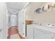 Hallway with hardwood floors and bright, neutral paint leads to front door and laundry room at 4103 Christine Ln # E, Waxhaw, NC 28173