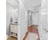 Hallway with hardwood floors and neutral paint connects the living spaces and half bath at 4103 Christine Ln # E, Waxhaw, NC 28173