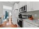Well-equipped kitchen with white cabinets, stainless steel appliances, and a view to the living room at 4103 Christine Ln # E, Waxhaw, NC 28173