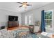 Cozy living room with hardwood floors, a ceiling fan, and a wall-mounted television at 4103 Christine Ln # E, Waxhaw, NC 28173