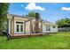 Back exterior of home featuring deck with pergola, lush lawn, and brick chimney at 4507 Mackinac St, Charlotte, NC 28269