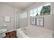 This bathroom boasts a soaking tub, glass-enclosed shower, and elegant fixtures at 4507 Mackinac St, Charlotte, NC 28269