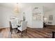 Bright dining area with chandelier lighting adjacent to an open kitchen and stylish decor at 4507 Mackinac St, Charlotte, NC 28269
