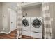 Convenient laundry room features modern washer and dryer on pedestals and shelving at 4507 Mackinac St, Charlotte, NC 28269
