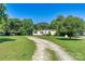 Charming single-story home with a long gravel driveway and spacious front yard with mature trees at 4905 Grassy Creek Rd, Denver, NC 28037