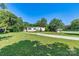 Inviting single-story home with a covered porch and well-maintained lawn and mature trees at 4905 Grassy Creek Rd, Denver, NC 28037
