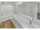 Well-lit bathroom with double sink vanity, large mirror, and tub/shower combo at 5163 Ficus Tree Ln, Charlotte, NC 28215