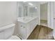 Bright bathroom features a double sink vanity, modern fixtures, and tile flooring at 5163 Ficus Tree Ln, Charlotte, NC 28215