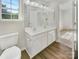 Bathroom featuring dual sinks, large mirror, and access to an adjoining room at 5163 Ficus Tree Ln, Charlotte, NC 28215