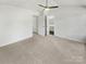 Spacious bedroom with neutral carpet, fan and ensuite bathroom with multiple doorways at 5163 Ficus Tree Ln, Charlotte, NC 28215