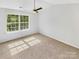 Sunlit bedroom with large window and ceiling fan, creating a serene atmosphere at 5163 Ficus Tree Ln, Charlotte, NC 28215