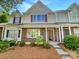 Charming townhouse with brick and siding facade, complemented by a well-manicured lawn at 5163 Ficus Tree Ln, Charlotte, NC 28215
